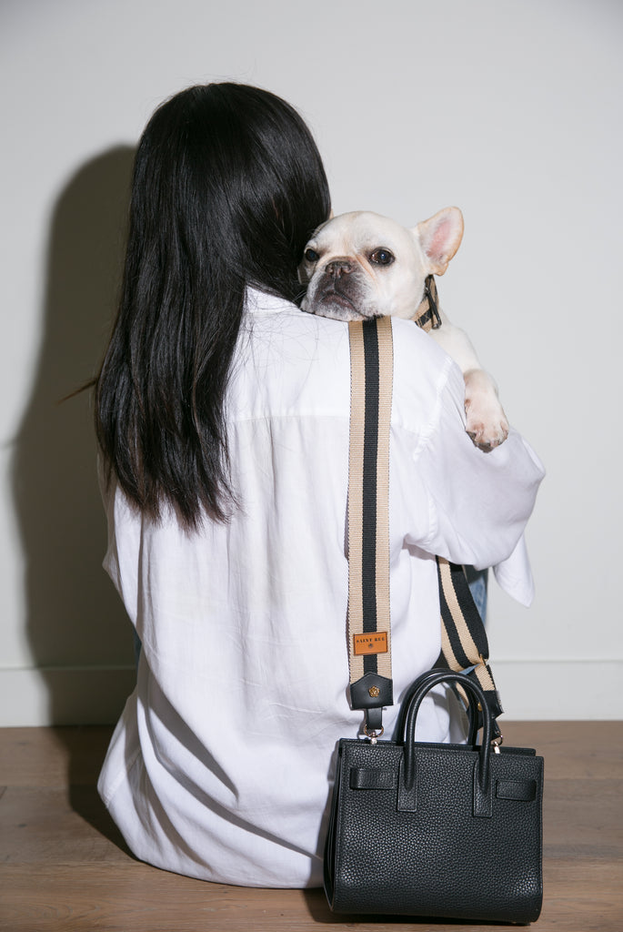 girl with french bulldog and purse with bag straps