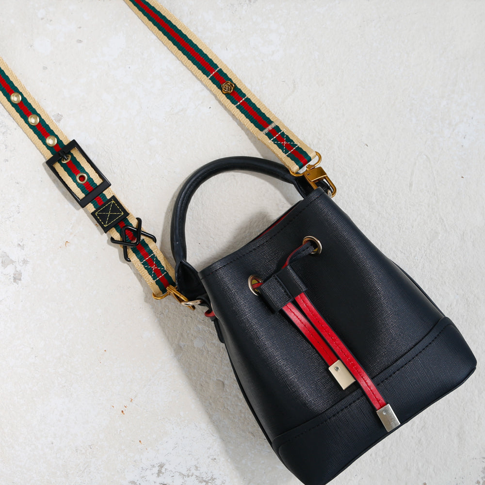 black leather bucket bag with red green beige bag strap