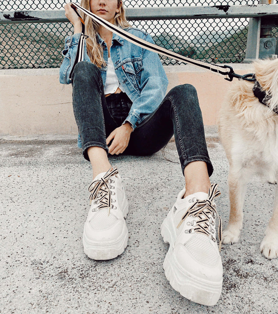 girl with shoelaces and matching dog leash